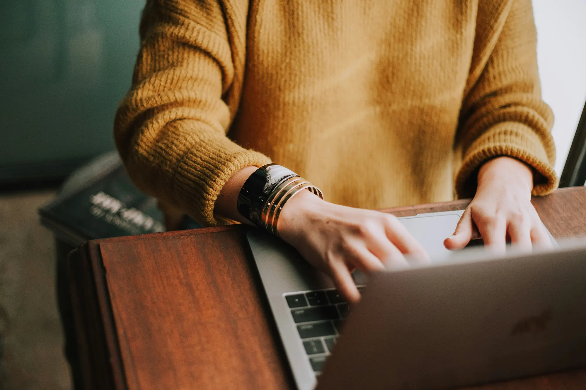 A young woman manages her credit card account online on her laptop.