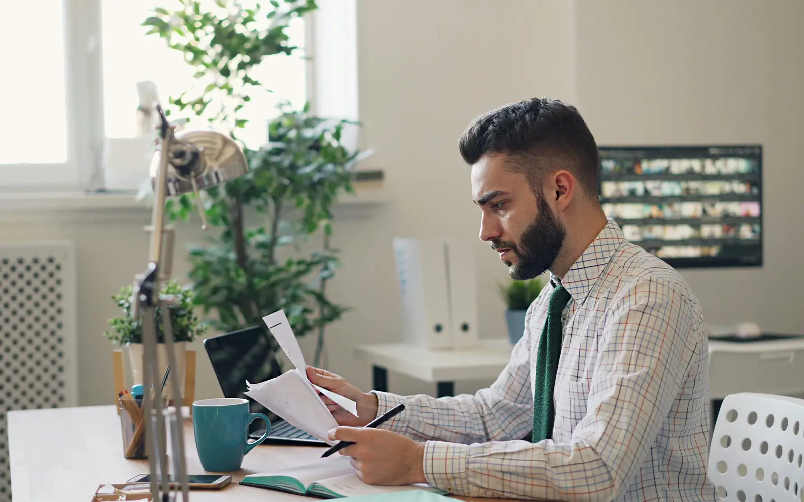 A man reviewing an operating agreement in his office.